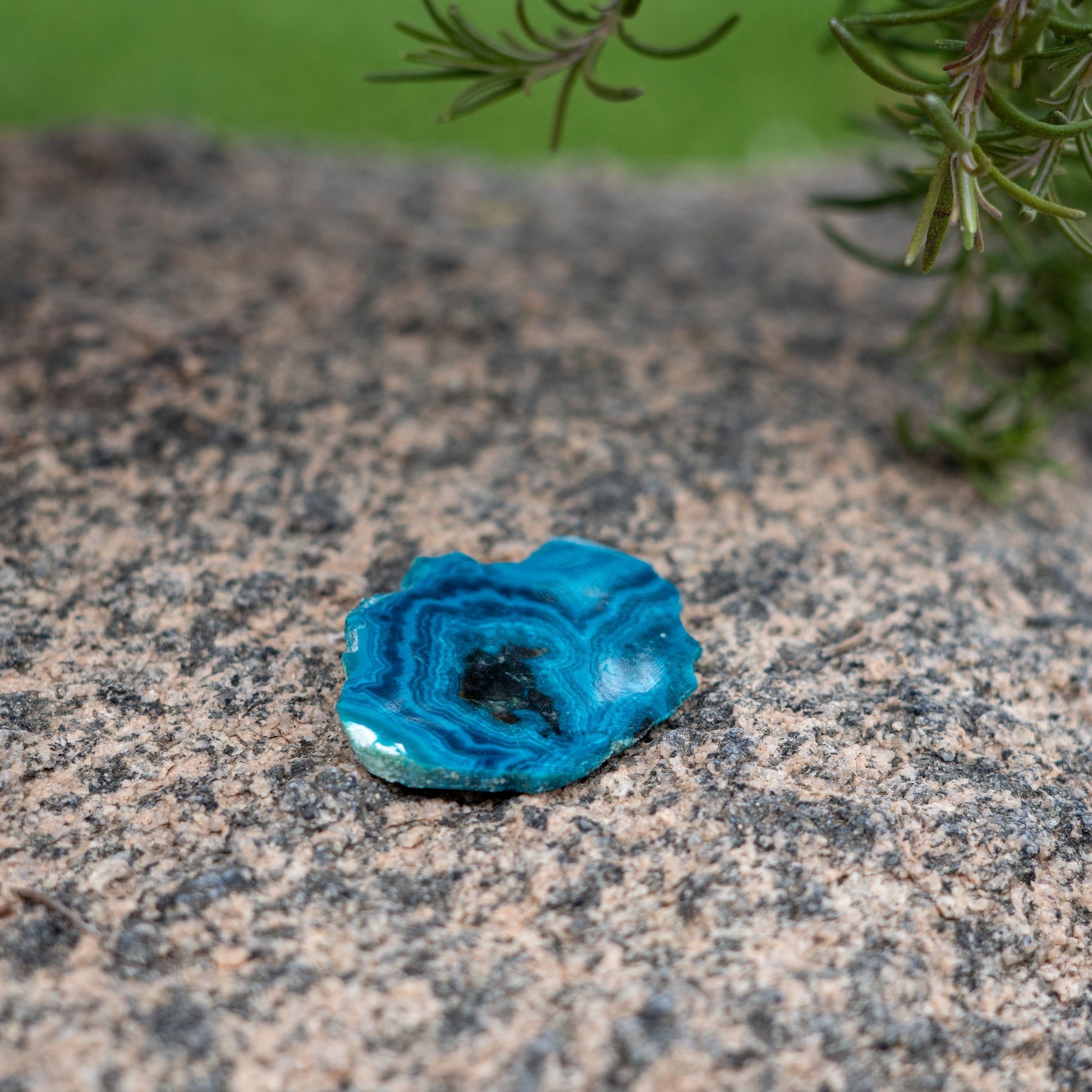 a blue chrysocolla crystal slice in a natural and serene setting to enhance spirit and energy