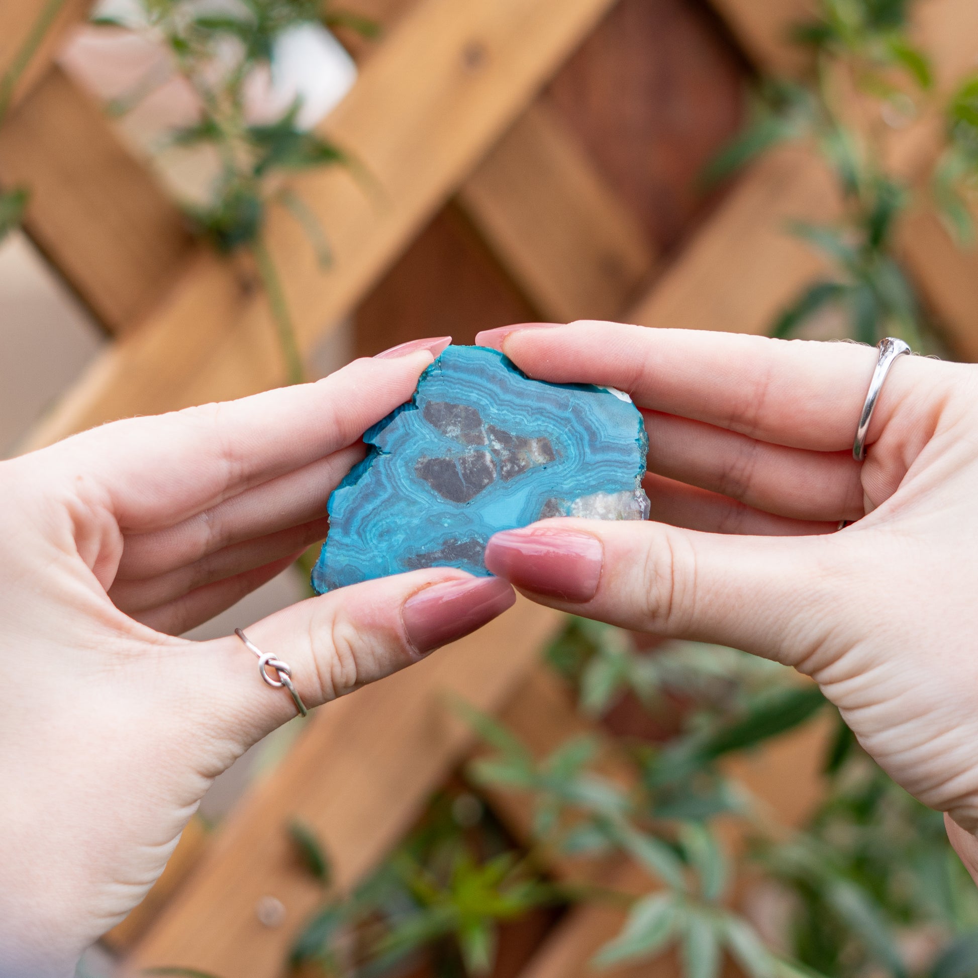 Chrysocolla crystal from Arizona being held in the hands of an energy worker. Chrysocolla is good for feminine hormone balance. 