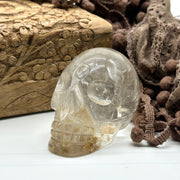 Clear Quartz Crystal Skull Carving with Golden Rutile Inclusions from Brazil