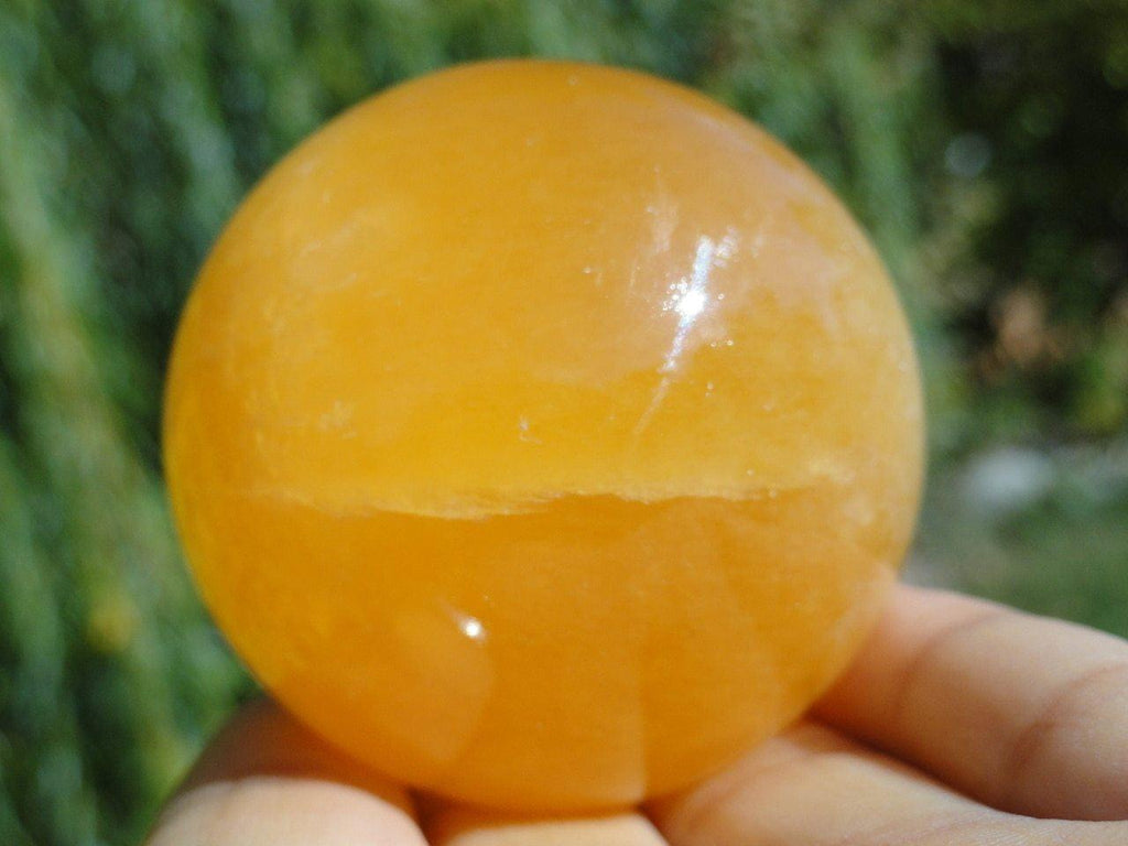 ORANGE CALCITE SPHERE - Earth Family Crystals