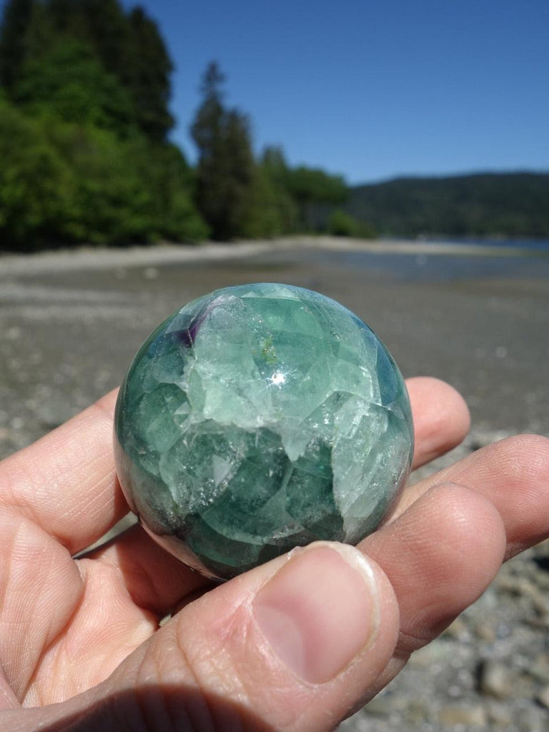 Pretty Green Fluorite Sphere Carving With Hints of Purple - Earth Family Crystals