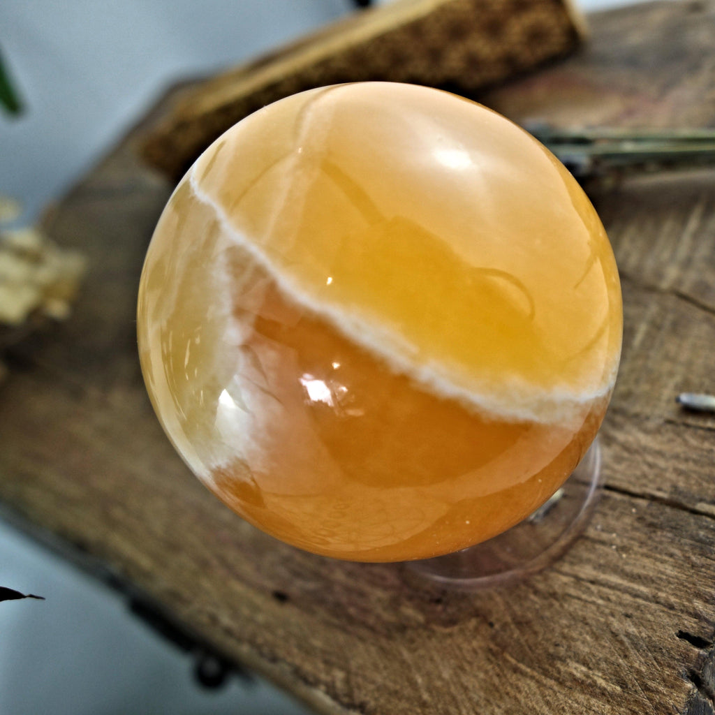 Juicy Orange Calcite Sphere Carving - Earth Family Crystals